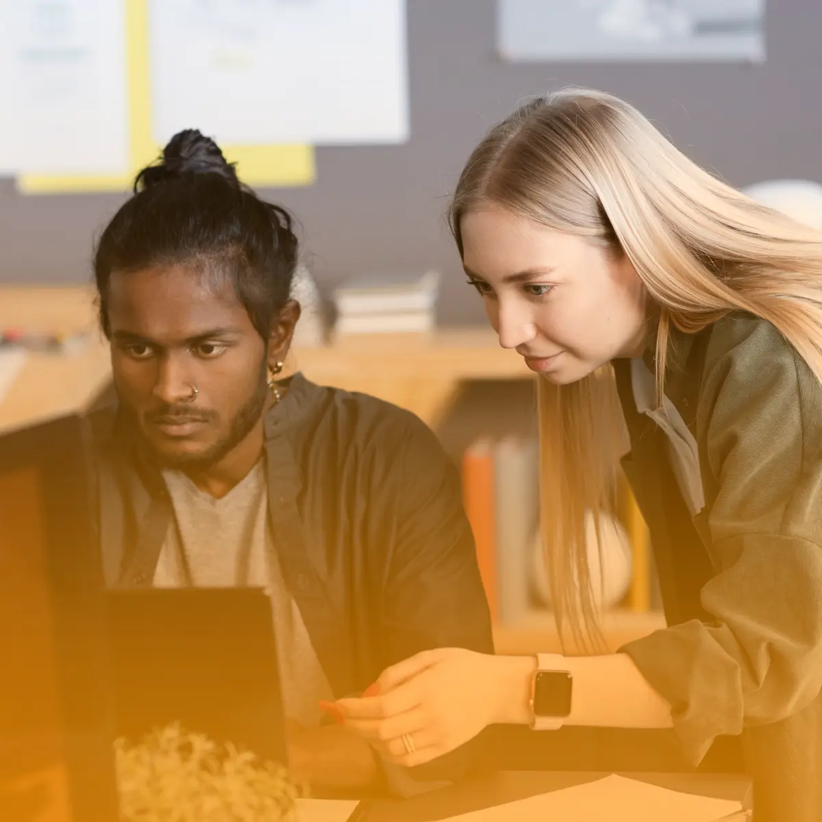 Students collaborating on a laptop for IT support